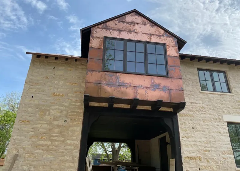 Copper metal panel facade on a stone building for Skylight Installation in Newport Beach
