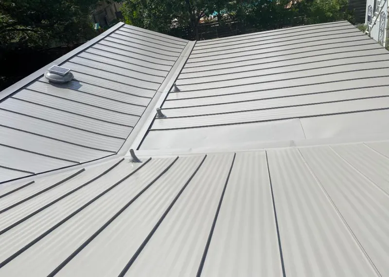 Solar attic fan installed on a metal roof for Roof Ventilation in Newport Beach